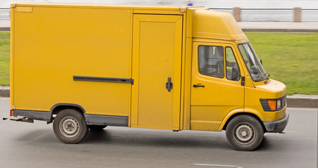 Yellow truck on asphalt road