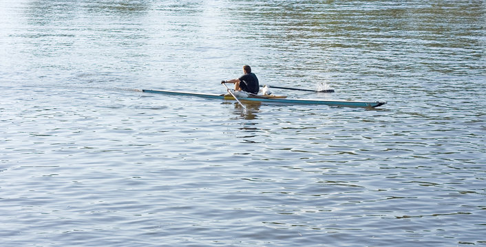 one single sculler rower oarsman rows in boat