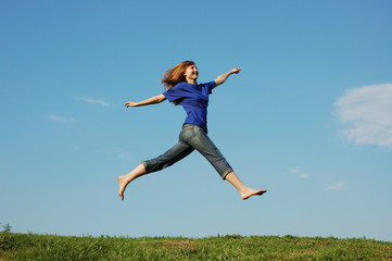 Jumping girl on a background sky