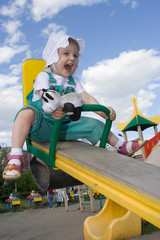 pretty happy baby rock on swing on blue sky with clouds