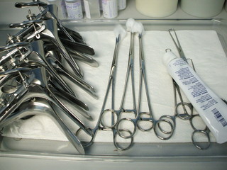 Pile of speculums on a tray in gynecologist office 