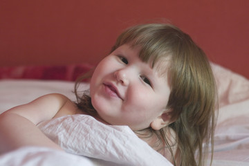 little girl is waking up and smiling