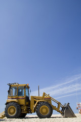 a Bulldozer on the beach removing sand