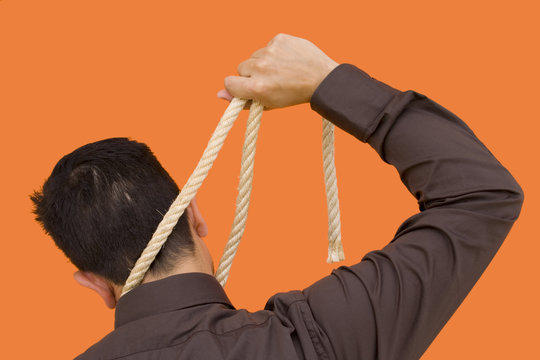 A businessman trying to hang him self