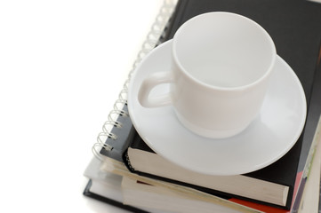pile of books and white cup