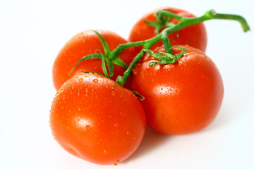 Bunch of red juicy tomatoes isolated on white