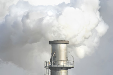 factory chimney producing a smoke