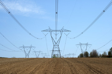 Ploughed land ready for cultivation and electricity pylons.