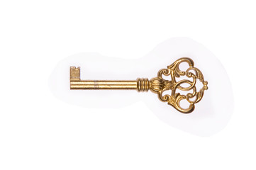 old golden metal key with white back ground