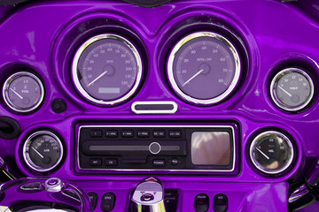 Close-up view of bright purple motorcycle dashboard