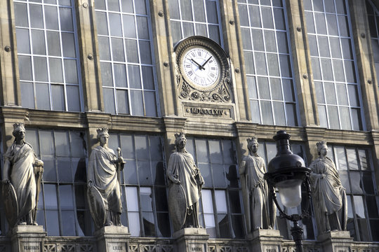 Paris train station with clock and statues