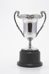 A silver championship cup, sports trophy award.