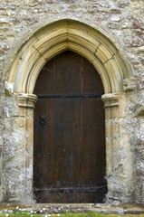 Fototapeta na wymiar A church door with a stone arch