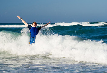 Man jumping into ocean waves