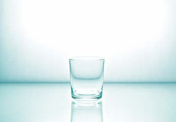 Glass on a light glossy surface. Light green toning.