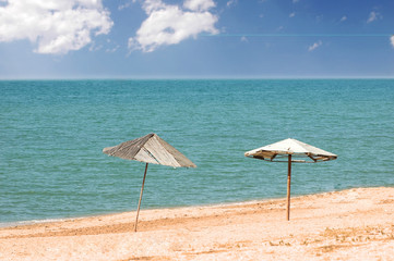 Two parasols on the beach in summer