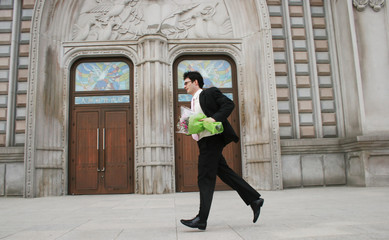 Man with a bouquet of flowers running