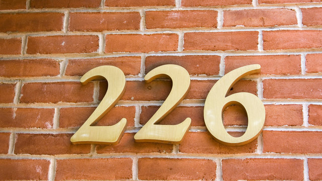Brass Numbers on a Traditional Brick Wall