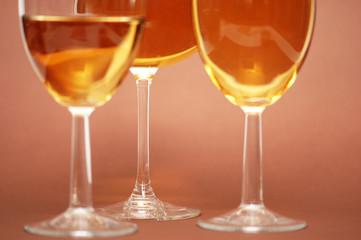 Three wine glasses on the biege  background