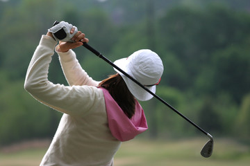 Lady golf swing action at practice ground