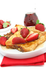 French toast with strawberries and maple syrup.