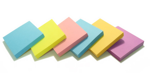 Colorful post its lined up, isolated over white