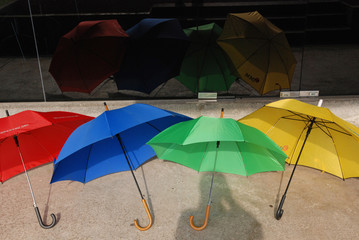 Fototapeta na wymiar Colorful umbrellas on the stadium seats