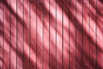 Detail of red wooden wall with shadows