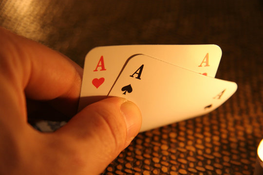 A poker player with a good hand of two aces