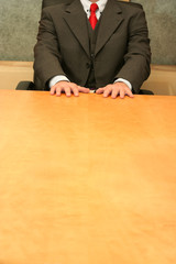 Business-man waiting at the desk, open hands on the desk.