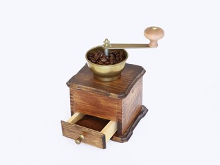 Ancient coffee grinder on white background