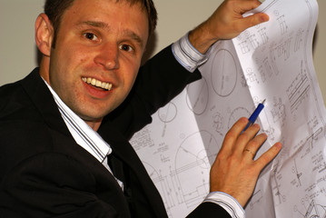 architect / engineer man with plans in a construction set