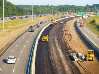 Asphalt being laid on freeway construction project