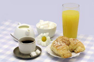 Almond croissant with a good cup of coffee and orange juice.