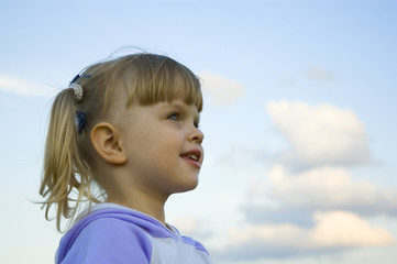 The little girl plays on a meadow