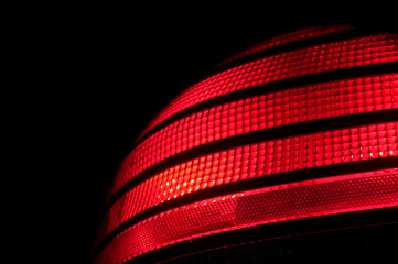 A red plastic automobile tail light signal.