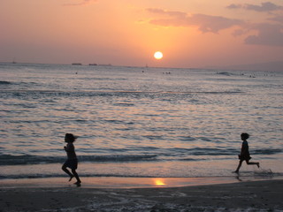 Shadows of children running on the beach
