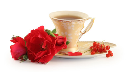 Cup of tea, cookies and rose isolated on white.