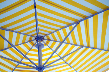 An opened beach, pool or patio umbrella.