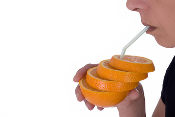 Woman drinking from a sliced orange over white background