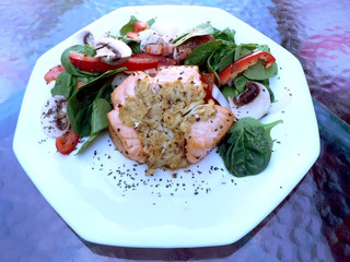 dinner of salmon stuffed with crabmeat and salad on the side