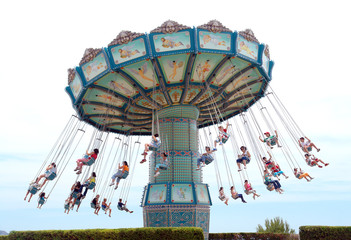 people having fun with riding a modest carrousel