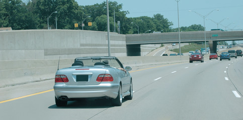 Convertible automobile speeding on the highway