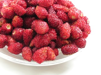 wild strawberries on a glass plate 