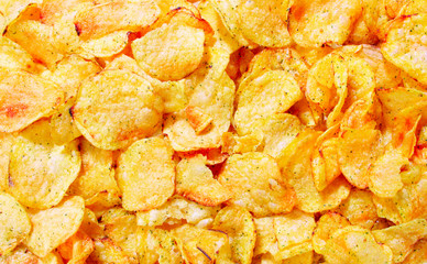 Potato chips close-up view from above, may be used as background