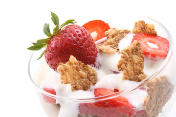 glass of yogurt fresh strawberries and cereals on white
