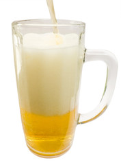 Glass mug with a jet foamed by cold beer 
