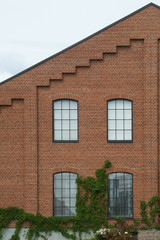 Brick wall with slanting roof and four windows