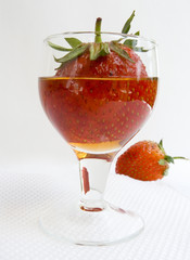 Strawberry in a wine-glass with a wine close up