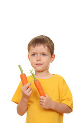 five years old boy eating fresh carrot isolated on white